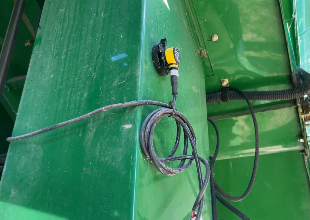 A FarmTRX optical sensor is installed on a combine 